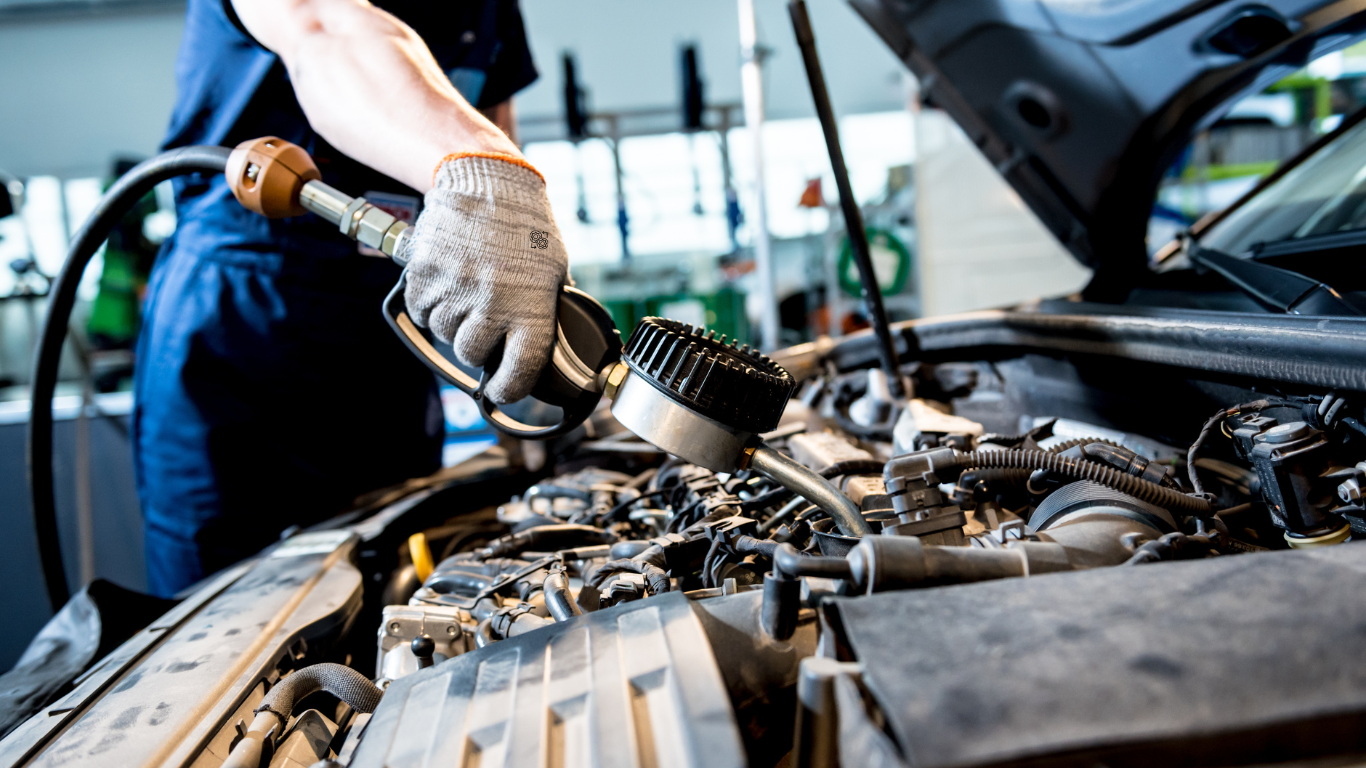 Image placed on (Full Car Inspection) page. It showing one personnel holding the equipment towards the component and system at the front of the hood