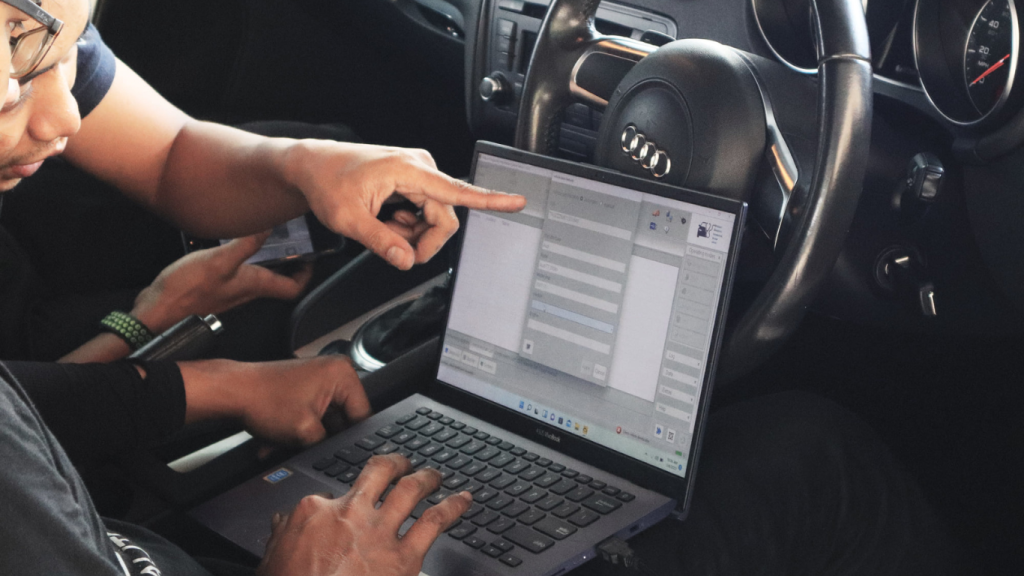This image placed on (Pre Purchase Inspection). It shows two personnel inside of the car during inspection and maintenance