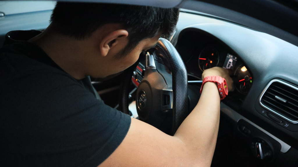 This image placed on (Pre Purchase Inspection). It shows one personnel inside of the car during inspection and maintenance
