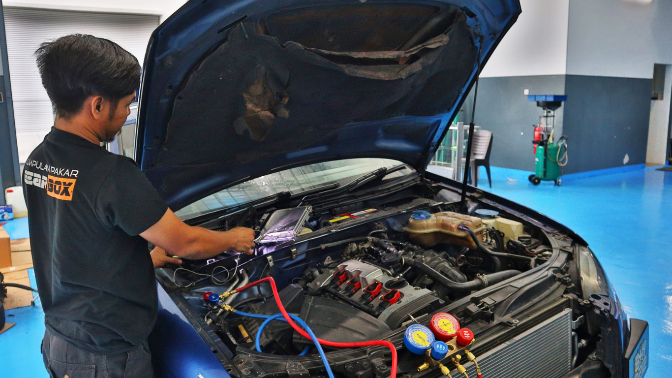 This image placed on (Pre Purchase Inspection). It shows one personnel infront of the car during inspection and maintenance