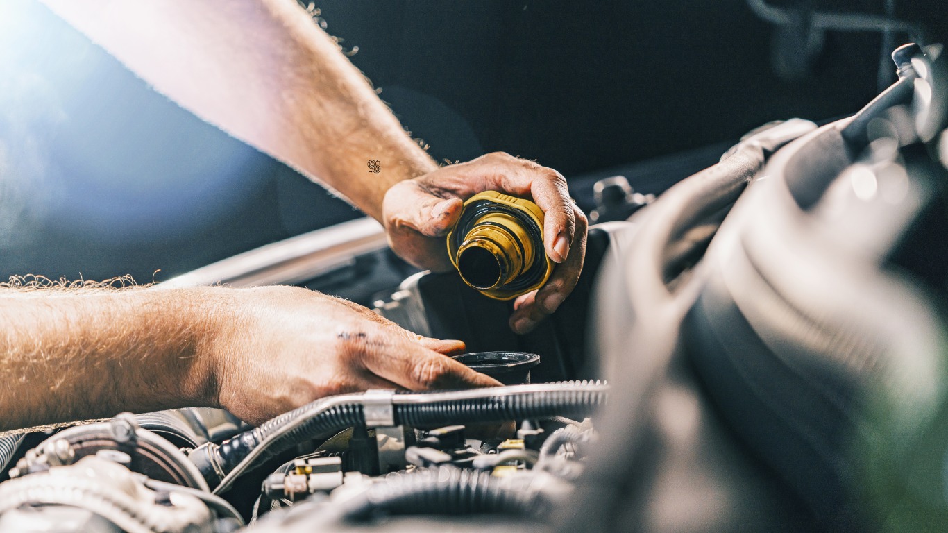 Image placed on (Home) page. And showing one male hand holding a tool during a car system maintenance